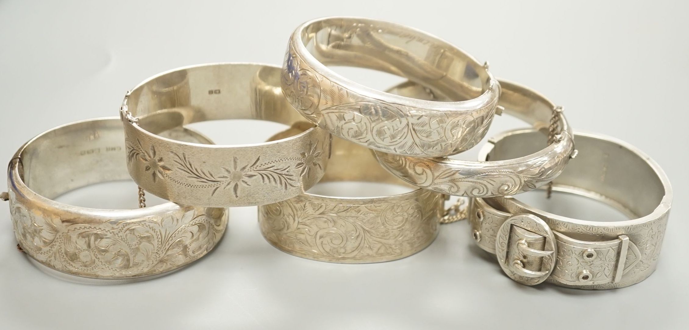 A Victorian silver bangle, Birmingham, 1885 and five later silver bangles.